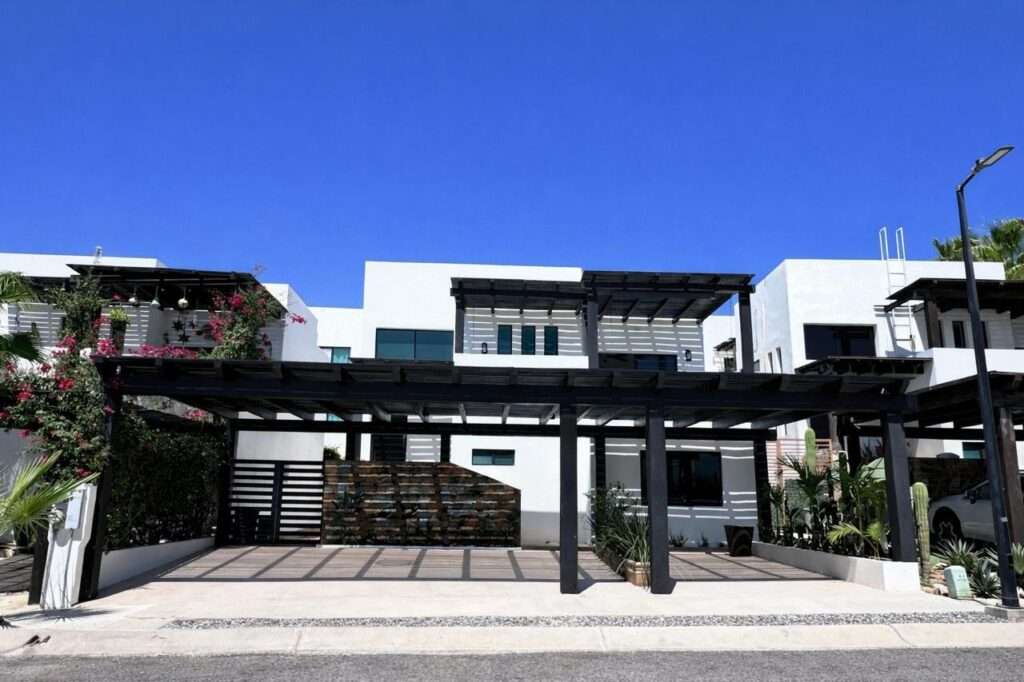 Los Cabos Casa Mex-Agaves Situated within the Casa Mexicana - Agaves community, this thoughtfully designed three-bedroom residence offers a functional and well-planned layout. The main level features a bedroom with an en-suite bathroom and walk-in closet, ideal for guests, multigenerational living, or those seeking stair-free access.A spacious outdoor terrace on the first floor, surrounded by tropical landscaping, provides a serene setting for both relaxation and entertaining. With multiple seating areas, it stands out as a unique feature within Casa Mexicana. The upper level includes two additional bedrooms, each with en-suite bathrooms and walk-in closets, along with the home's main living and kitchen areas. The indoor spaces are seamlessly connected to an additional terrace, enhancing the home's indoor-outdoor living appeal.Additional features include a dedicated laundry area, a two-car garage, and accordion-style hurricane shutters, combining comfort with practicality and peace of mind. – 12 isla santa margarita, Cabo Corridor, BS