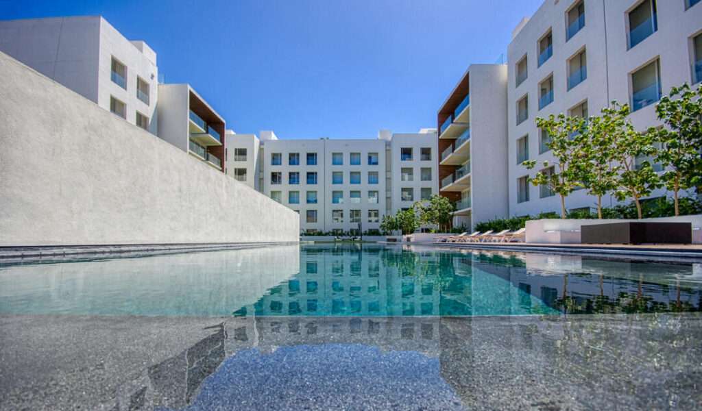 Los Cabos Marea Los Cabos Located in the exclusive Marea development, this 1,480 sq. ft. condo offers the premier downtown Cabo San Lucas lifestyle just 500 meters from Medano Beach. The contemporary, open-concept design features three spacious bedrooms--each with its own private balcony--and floor-to-ceiling windows that flood the sleek, white-cabinetry kitchen and living areas with natural light. This turnkey property is a lucrative opportunity for investors, coming fully furnished, equipped, and ready for immediate rental income with no renovations required. Residents enjoy premium community amenities, including 24/7 security, a lobby, a gym, and a sparkling pool. The standout rooftop terrace, with a jacuzzi , provides the perfect vantage point to take in the city – 8 Avenida Pescador, Cabo San Lucas, BS