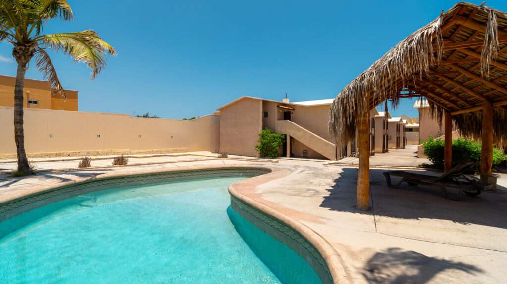 Los Cabos Villas Del Sol Great location, close to all amenities in Cabo San Lucas, walking distance to Medano Beach and to the CSL Marina, restaurants, bars, shops, supermarkets and all vibrant life in Cabo! This 115 m2 (1240 sqft) under AC condo has ceramic floor tiles, high vaulted ceilings, lots of natural light, back terrace with sink, electric water heater, AC mini splits and ceiling fans on each room, hardwood kitchen with propane stove, laundry closet, large living area, one parking space. Villa del Sol is a boutique gated community of only 22 private residencies with common palapa and pool area. Low HOAs. Walk everywhere, enjoy Cabo! – Lazaro Cardenas, Cabo San Lucas, BS