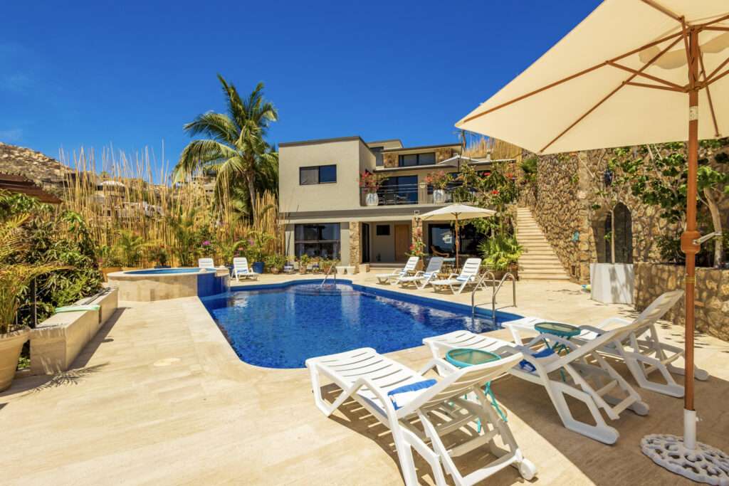 Los Cabos Palmilla Estates Discover a standout investment opportunity in coveted Palmilla Estates, where relaxed coastal style meets refined comfort. This single-story 3-bedroom, 3-bath home blends natural stone, warm wood beams, and a gourmet kitchen with high-end appliances, breakfast nook, and full bar. A generous entry courtyard opens to a heated pool, jacuzzi, outdoor kitchen, and a sun-washed yard overlooking the 9th fairway of the Jack Nicklaus Mountain Course. Eligible for a golf membership, it also makes an effortless vacation retreat with close access to Palmilla Beach, world-class amenities, and the charming San José town center. – Pedregal Camino Grande 40, Cabo San Lucas, BS