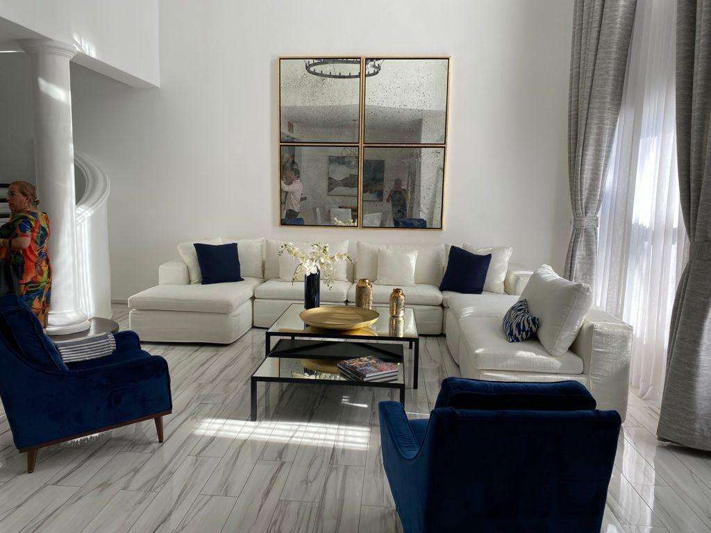 Los Cabos Villas De Oro Phase 1 Villa de Oro fantastic. Number 304 is very unique as it is one of a few town homes (most are upper or lower)that has a massive dramatic two story window that lights up the home. Downstairs has the impressive living and dining room. The kitchen has a new granite counter, a breakfast area and a bar for guests to enjoy the activity in the kitchen. Outside living with a big space to dine and sit around the large stone fireplace. Upstairs there are two bedroom suites, one of which has an outside terrace to enjoy the ocean for sale